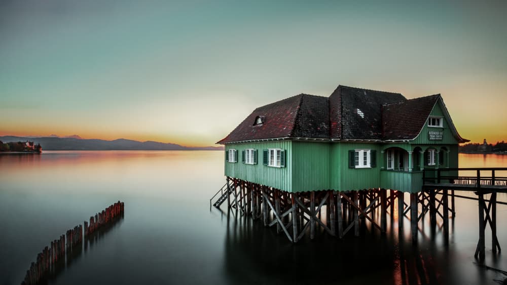 Green Stilt House Sunset by Martin Steeb — canvas wall art