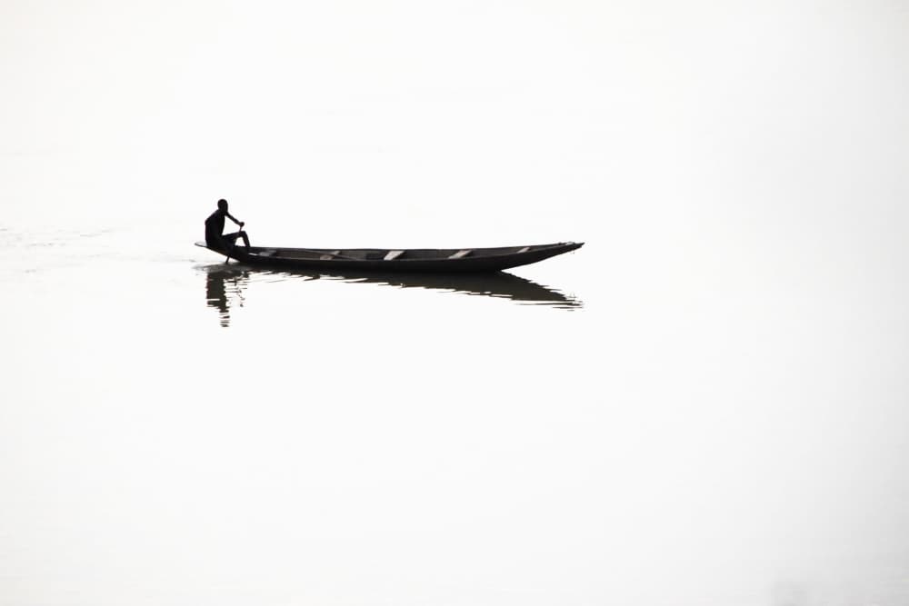 Lone Boatman Reflection by Florent Dirk Thies — canvas wall art