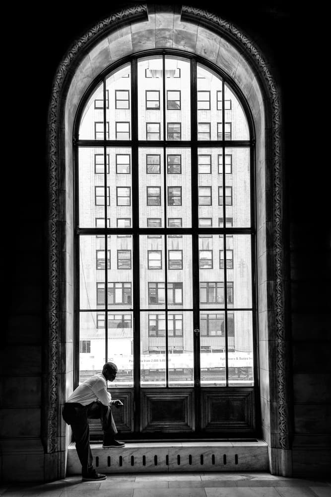 Man at City Window by Massimo Della Latta — canvas wall art