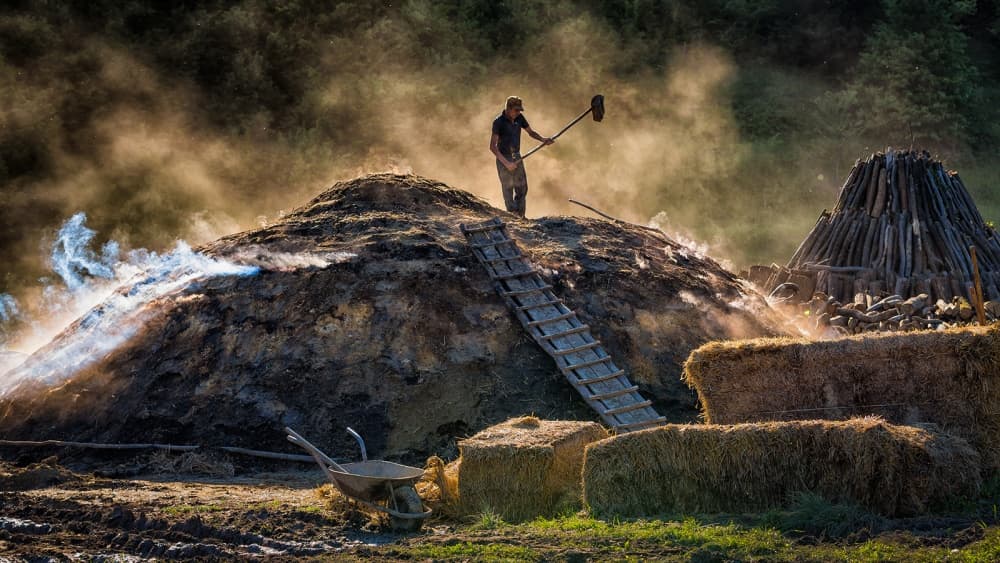 Man Making Charcoal by Adrian Popan — canvas wall art