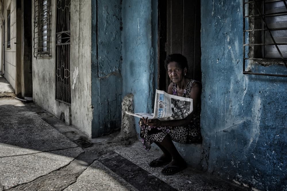 Woman Reading Street News by Pavol Stranak — canvas wall art