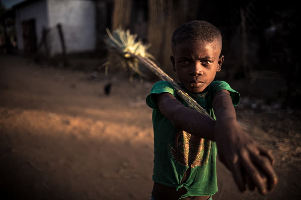 African Boy's Direct Gaze by Marco Tagliarino — canvas wall art