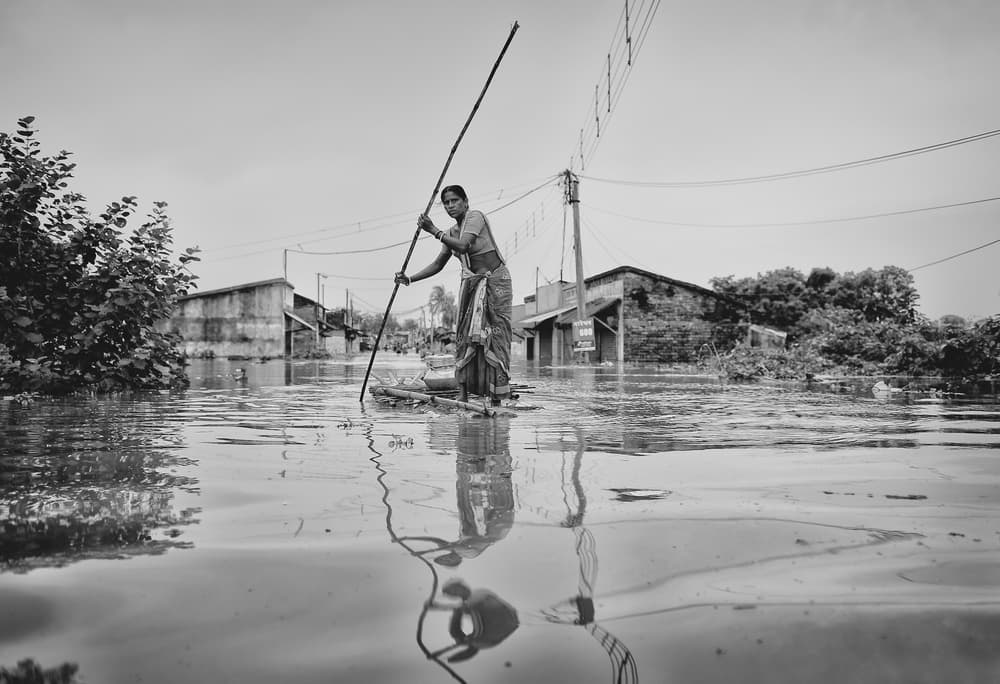 Woman Poling Floodwaters by Avishek Das — canvas wall art