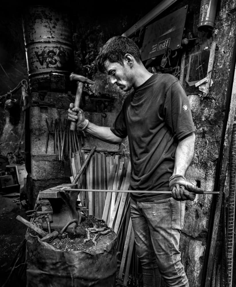 Focused Blacksmith At Work by Bashar Alsofey — canvas wall art