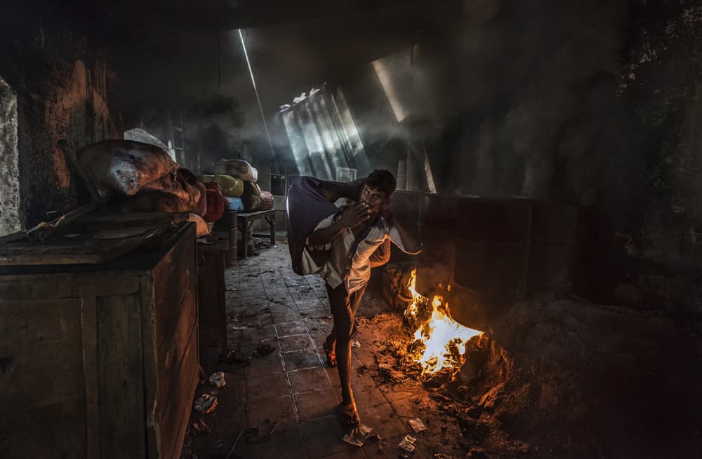 Man Working by Fire by Joxe Inazio Kuesta Garmendia — canvas wall art