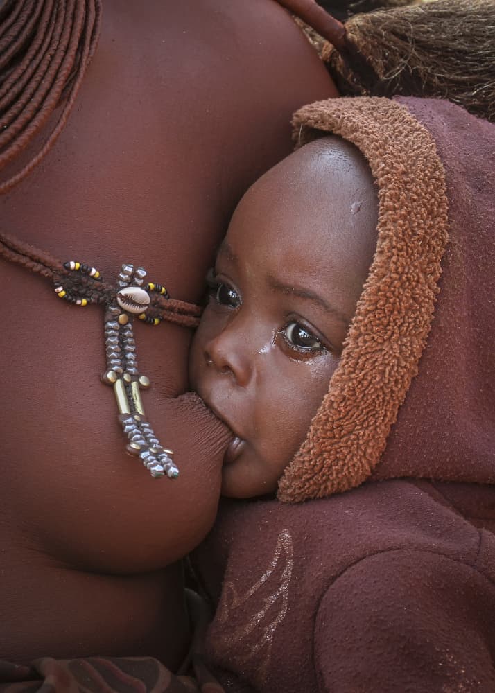 Himba Mother Feeding Baby by Raymond Ren Rong Liu — canvas wall art