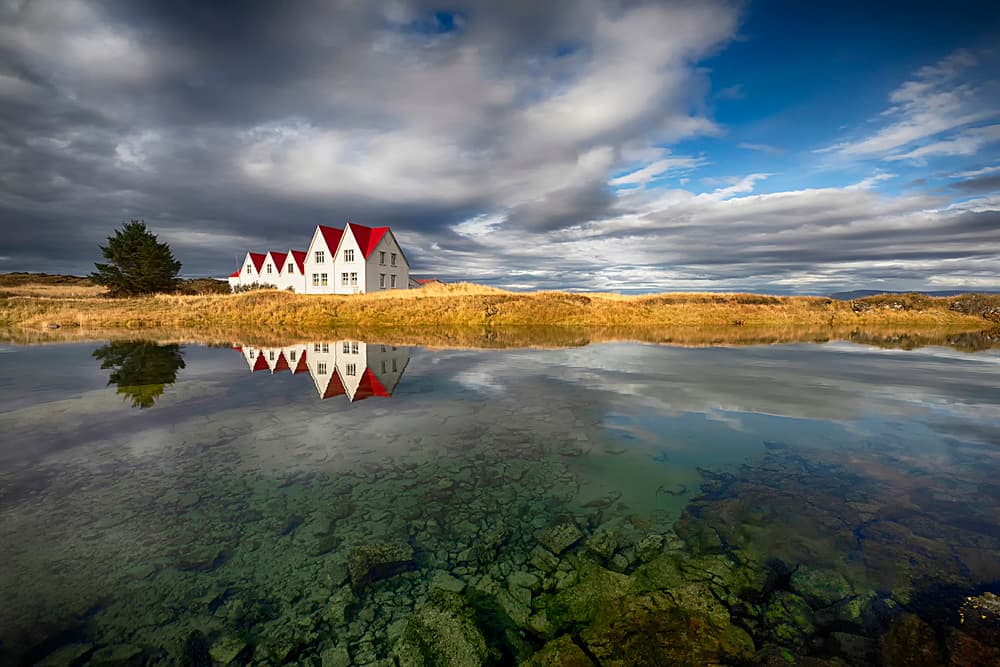 Reflected Red Roof Houses by Þorsteinn H. Ingibergsson — canvas wall art