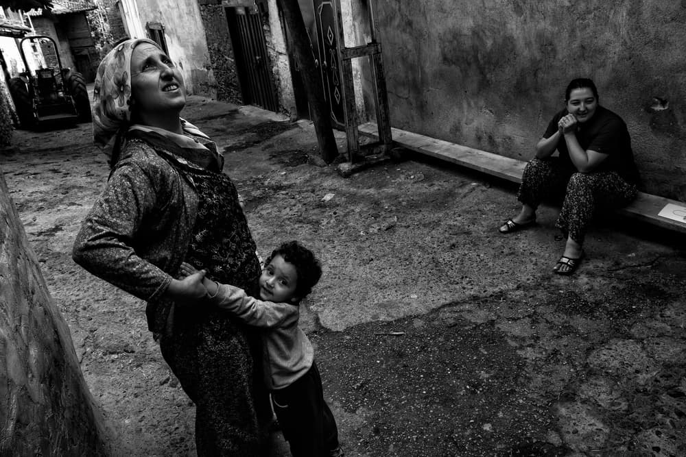 Street Life Embrace by Ali Ayer — canvas wall art