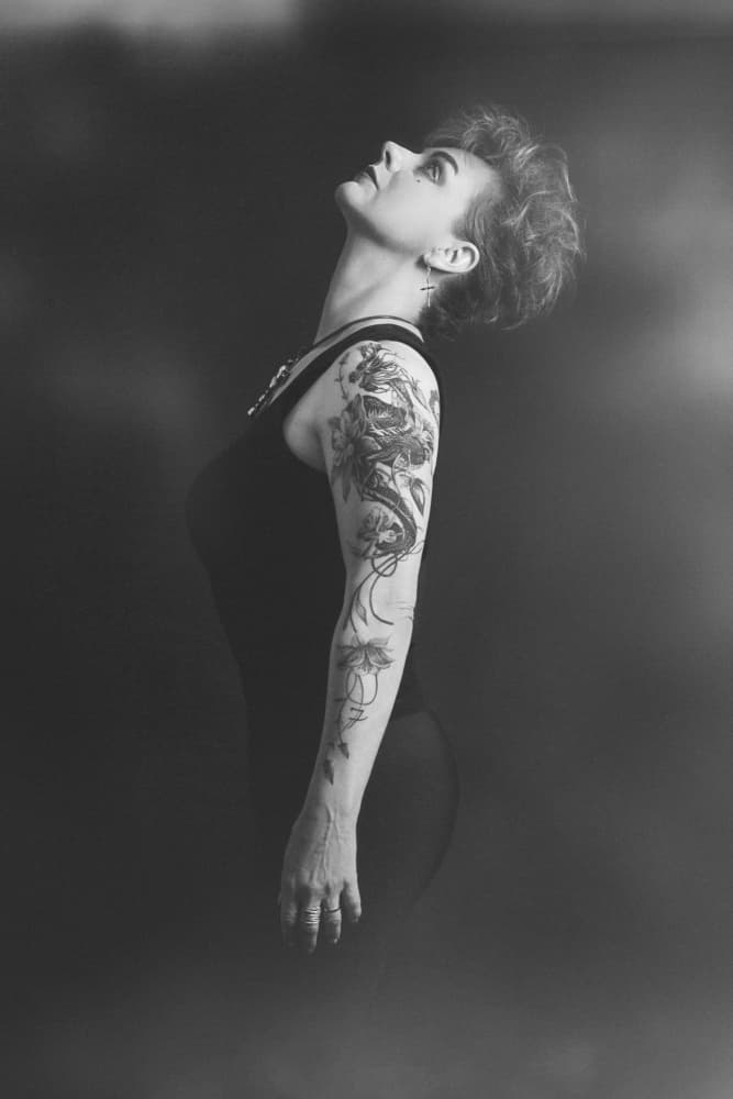 Tattooed Woman Looking Up by Carmen Watkins — canvas wall art