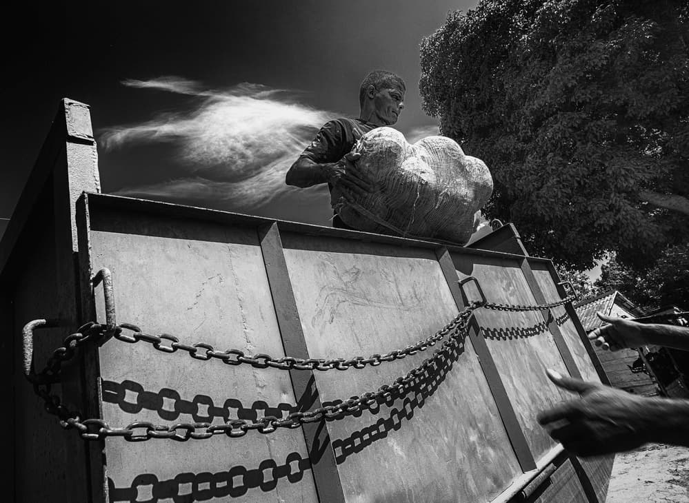 Man Lifts Rock by Andy Bauer — canvas wall art