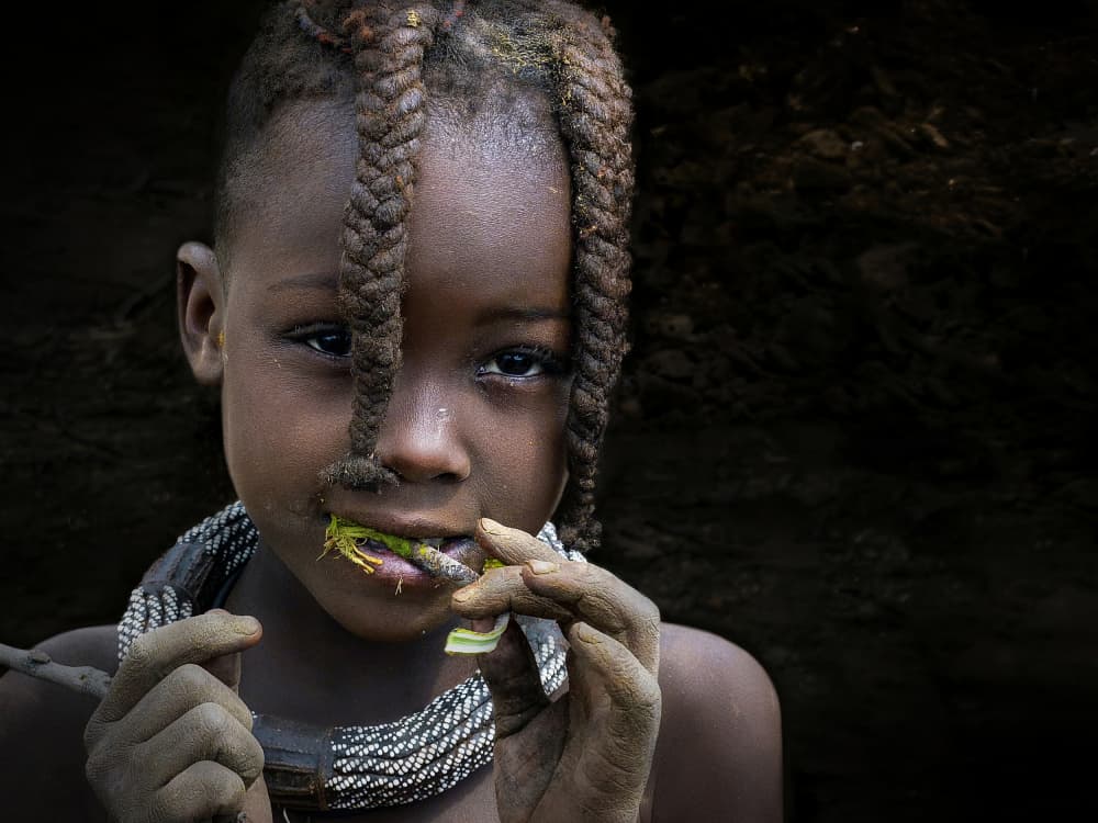 African Girl Eating Leaf by Irene Perovich — canvas wall art
