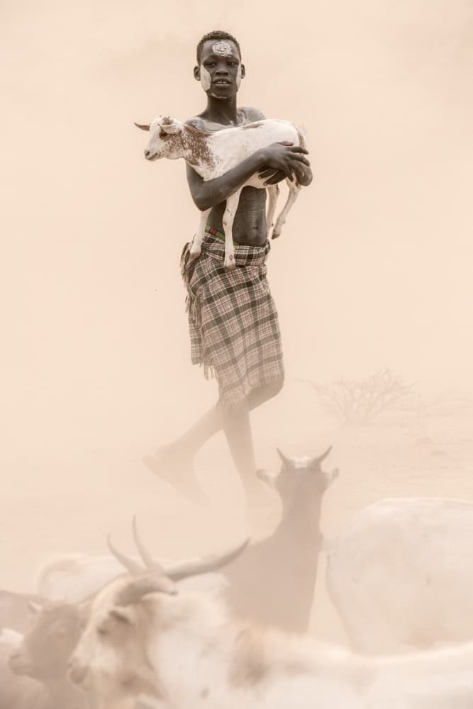Tribal Boy Holding Goat by Trevor Cole — canvas wall art