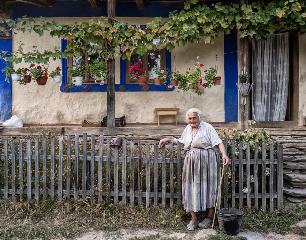 Elderly Woman Village Home by Andrei Nicolas - The Traveler — canvas wall art