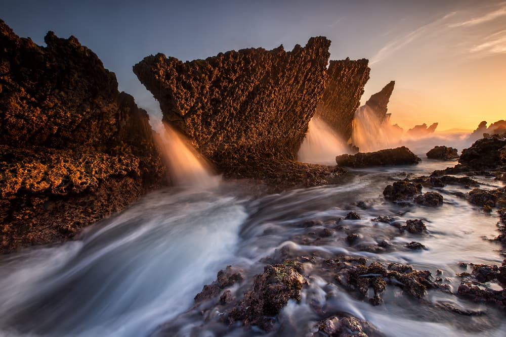 Golden Rocky Shore Waves by Gunarto Song — canvas wall art