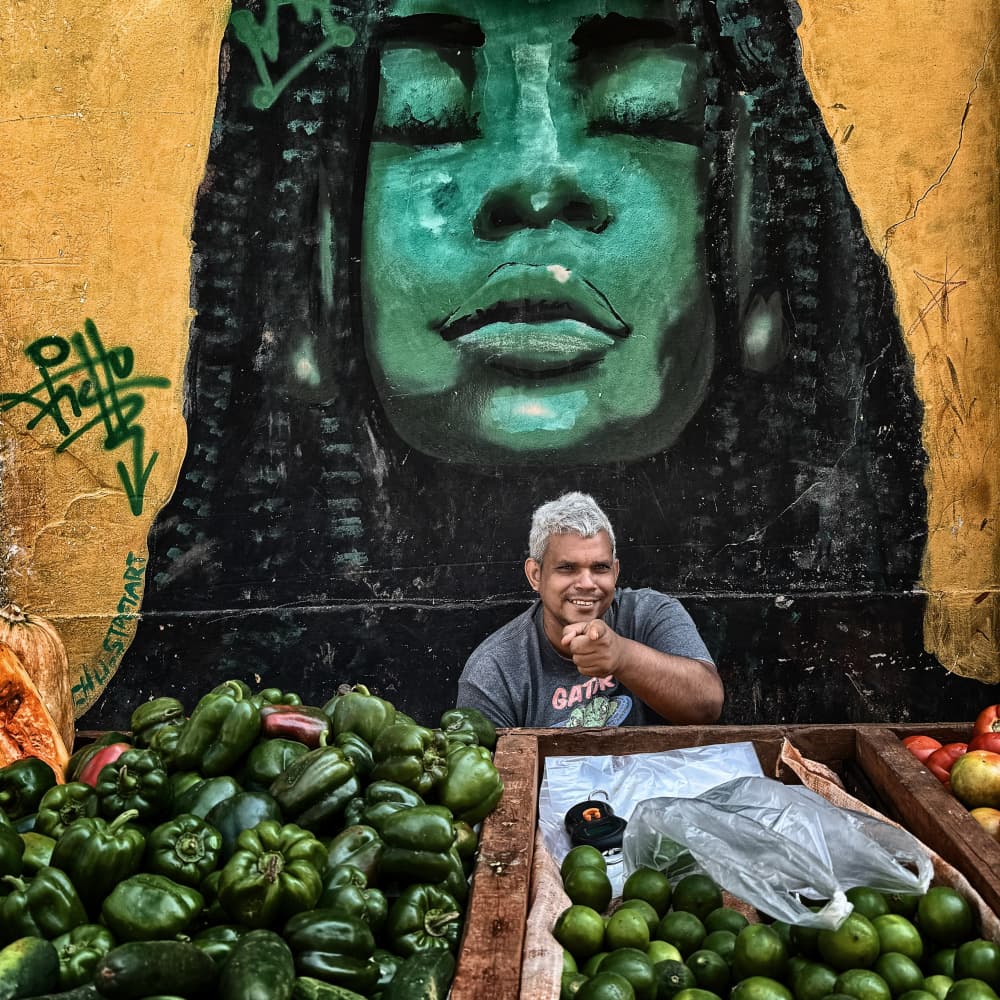 Smiling Vendor and Mural by Pavol Stranak — canvas wall art