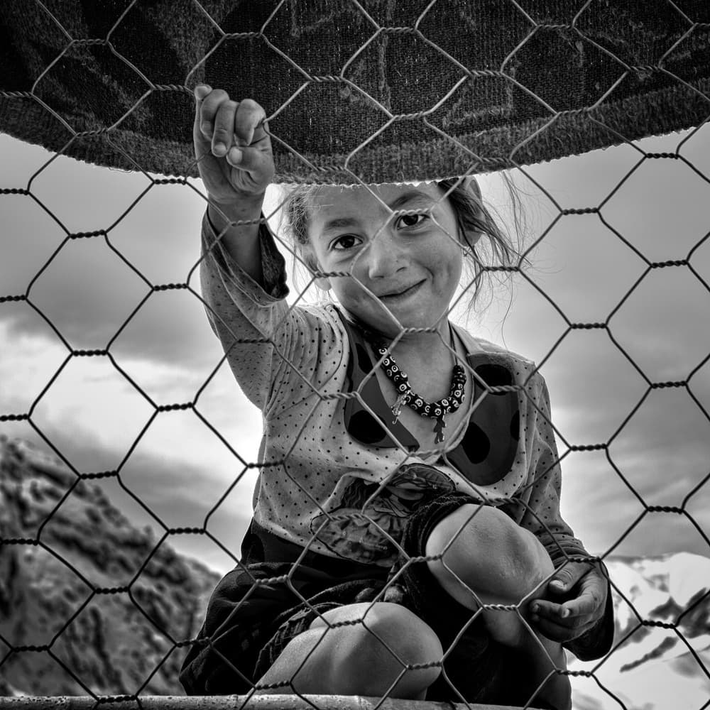 Smiling Girl Behind Wire by Mohammadreza Momeni — canvas wall art