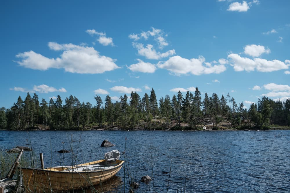 Rowboat on Calm Lake by Geertjan Plooijer — canvas wall art