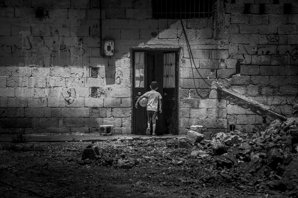Boy Enters Dark Doorway by Ramiz Sahin — canvas wall art