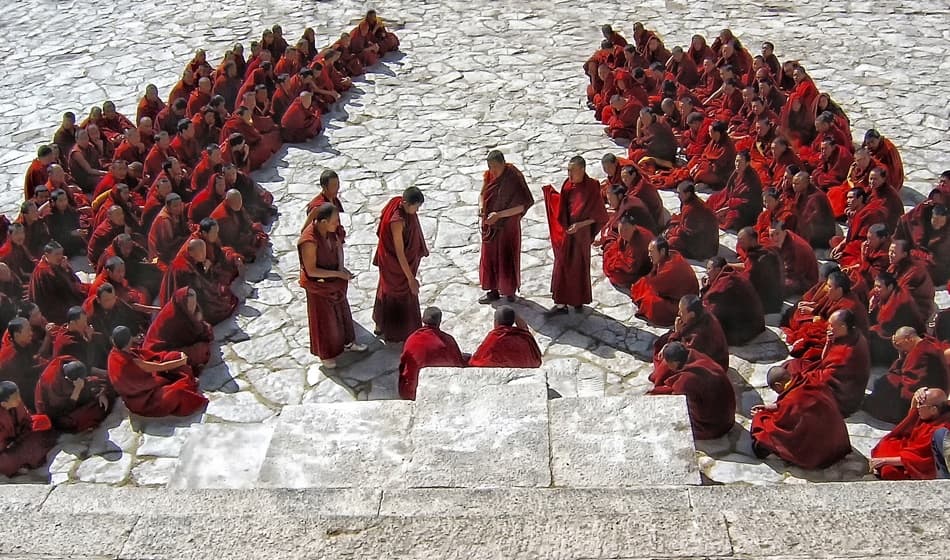 Monks Courtyard Debate by Yvette Depaepe — canvas wall art