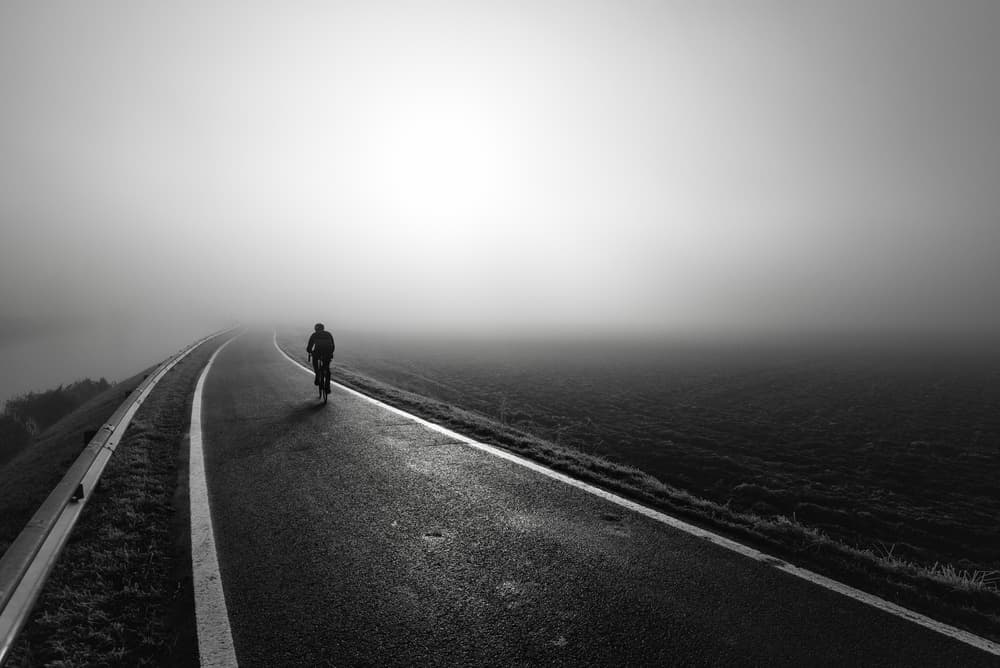 Misty Road Cyclist by Christophe Staelens — canvas wall art