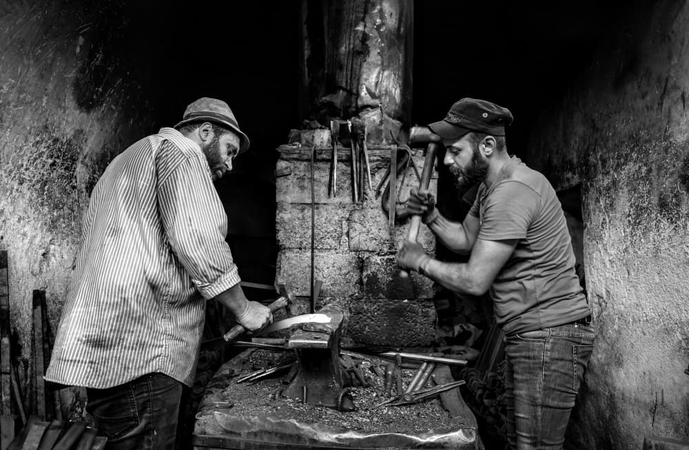 Blacksmiths Forging Metal by Bashar Alsofey — canvas wall art