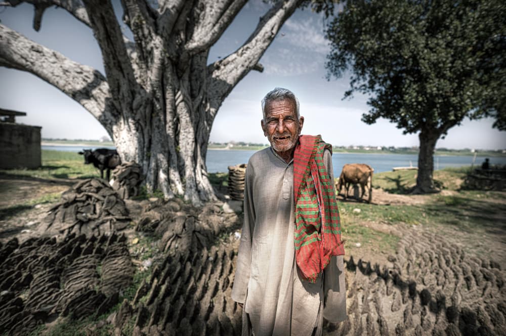 Village Man By River by Waldemar Szmidt — canvas wall art