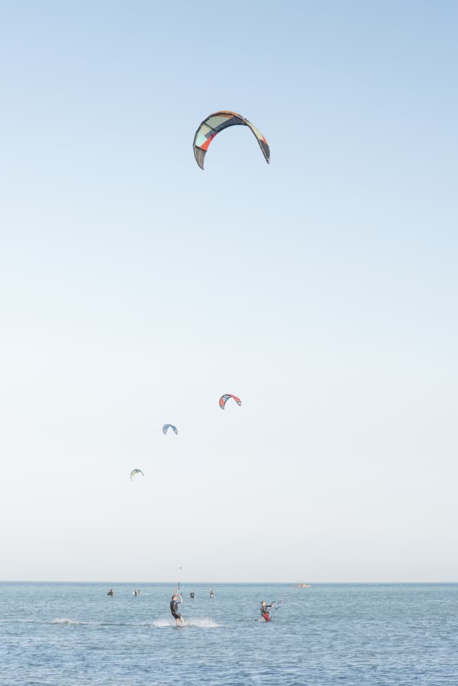 Kitesurfing Under Vast Sky by Lynann Colligan — canvas wall art