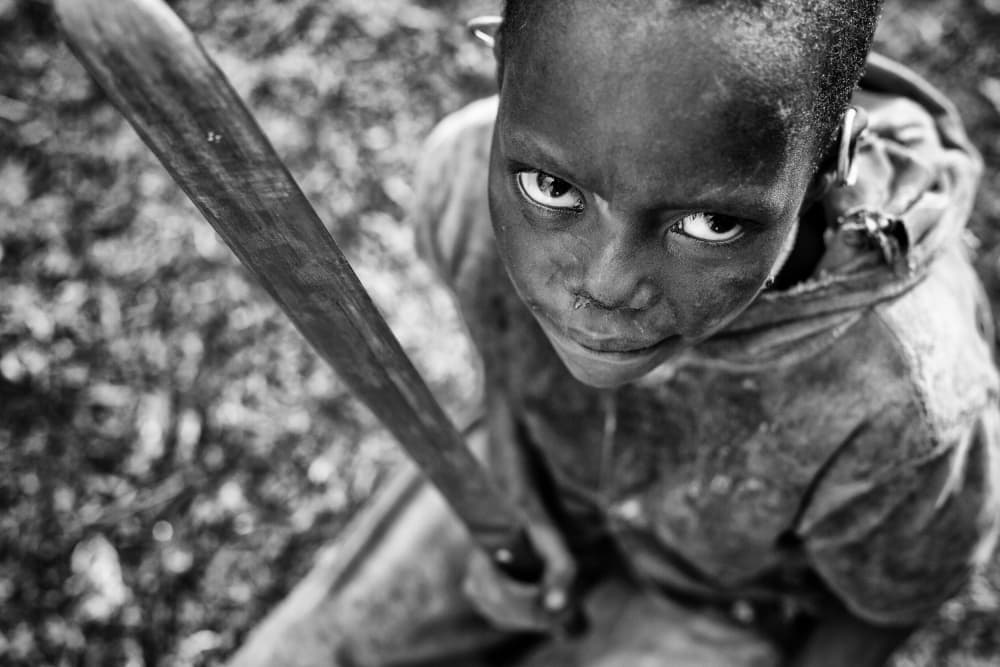 Intense Boy with Stick by Goran Jovic — canvas wall art