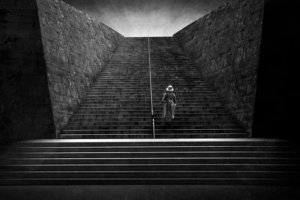 Solitary Figure Climbing Stairs by Ekkachai Khemkum — canvas wall art