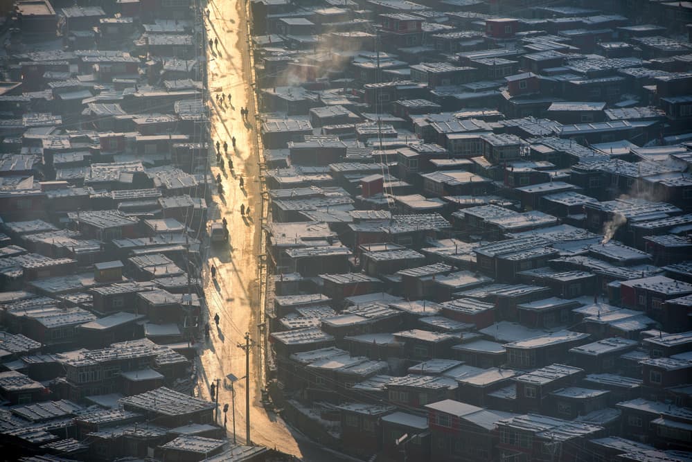 Winter Town Sunlit Path by Sarawut Intarob — canvas wall art