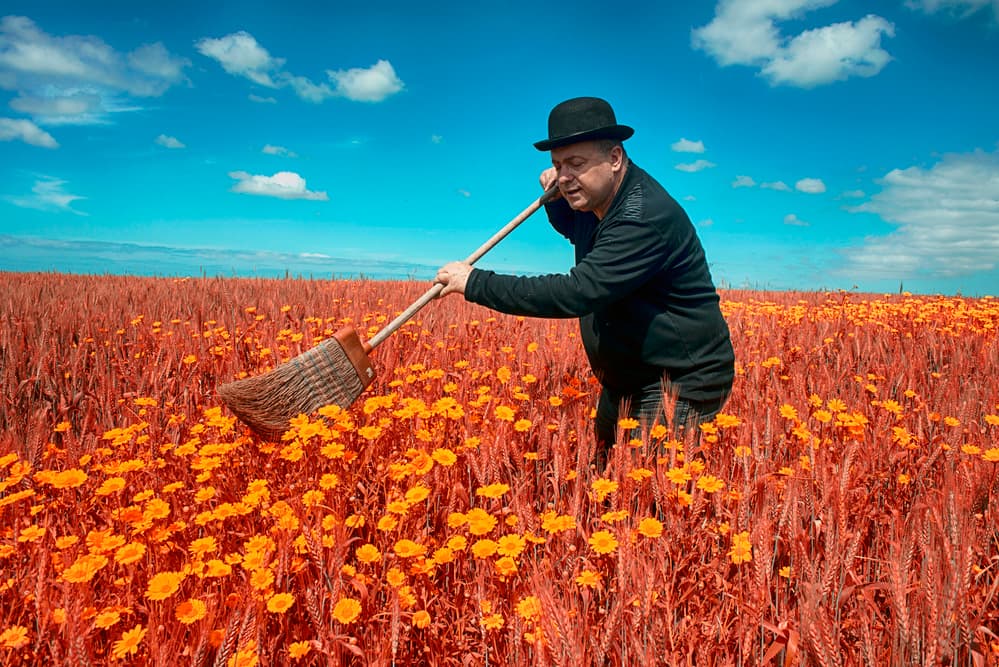Man Sweeping Flower Field by Miki Meir Levi — canvas wall art