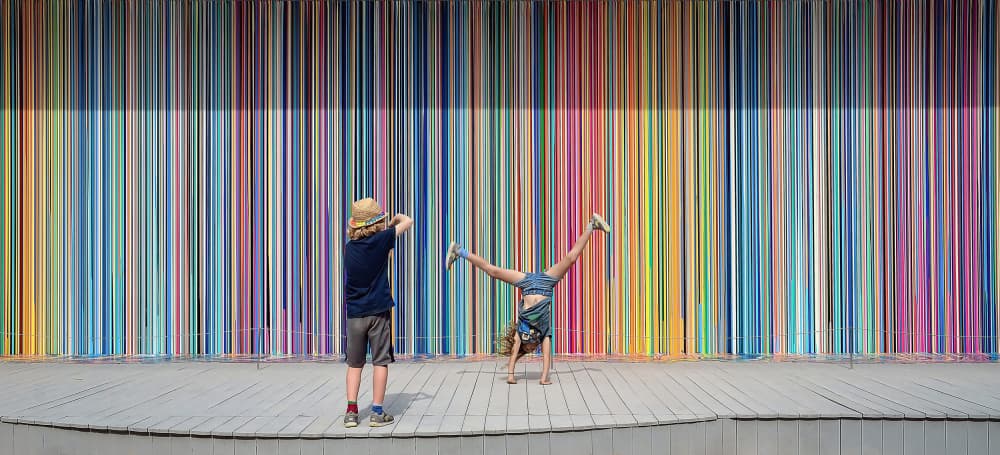 Children Play Colorful Stripes by Primož Kožuh — canvas wall art