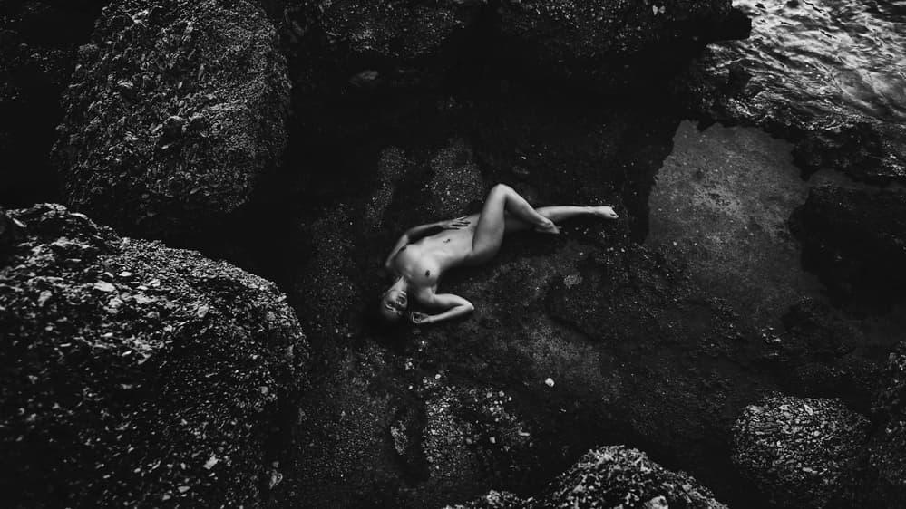 Nude Woman on Dark Rocks by Goran Jovic — canvas wall art