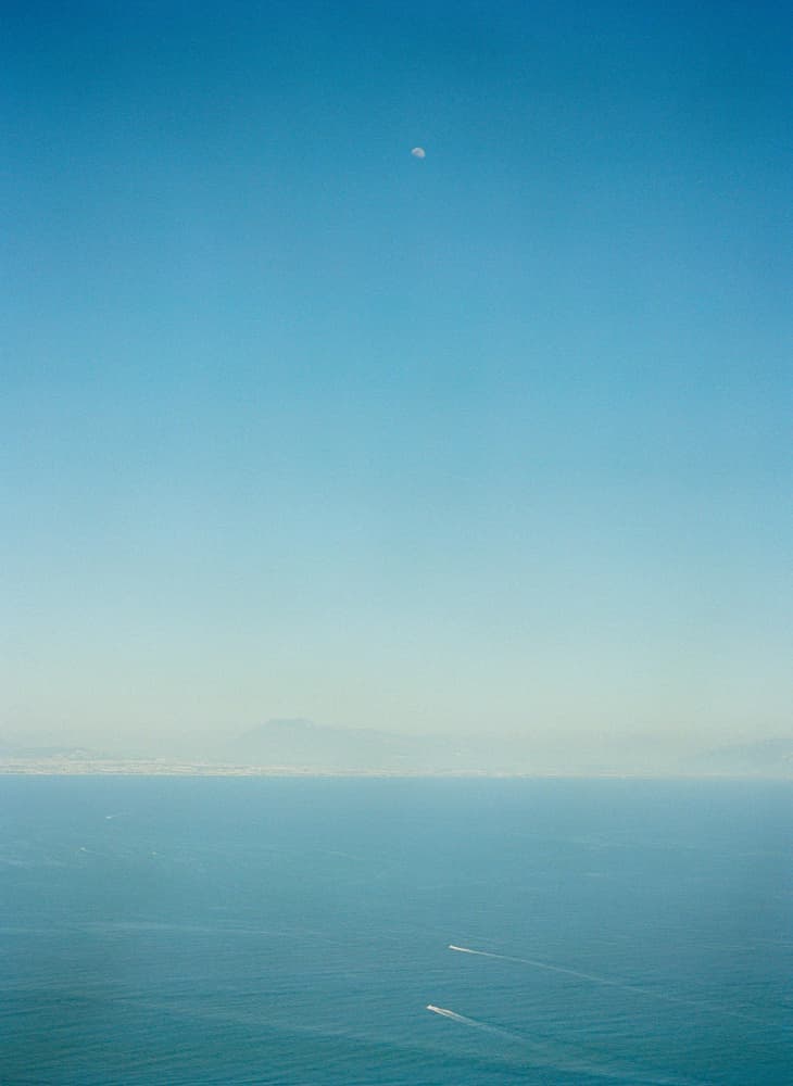 Distant Moon Over Ocean by Bethany Young — canvas wall art