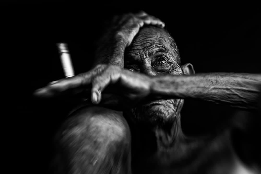 Pensive Old Man Smoking by Andi Halil — canvas wall art