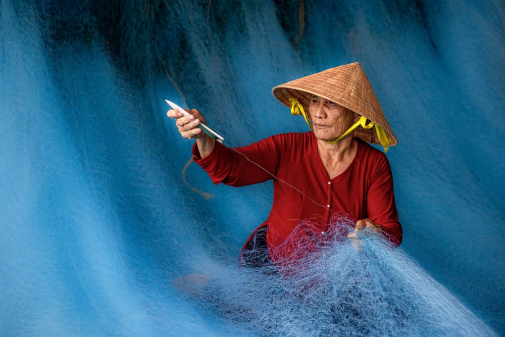 Vietnamese Woman Mending Nets by Sally Widjaja — canvas wall art