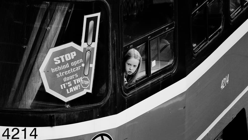 Young Girl Streetcar Gaze by Jian Wang — canvas wall art