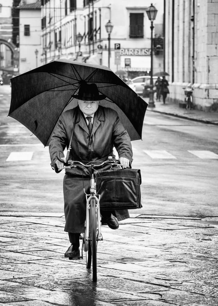 Gentleman Cycling In Rain by Massimo Della Latta — canvas wall art