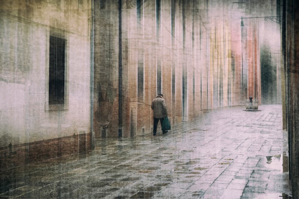 Lone Figure Wet Street by Roswitha Schleicher-Schwarz — canvas wall art