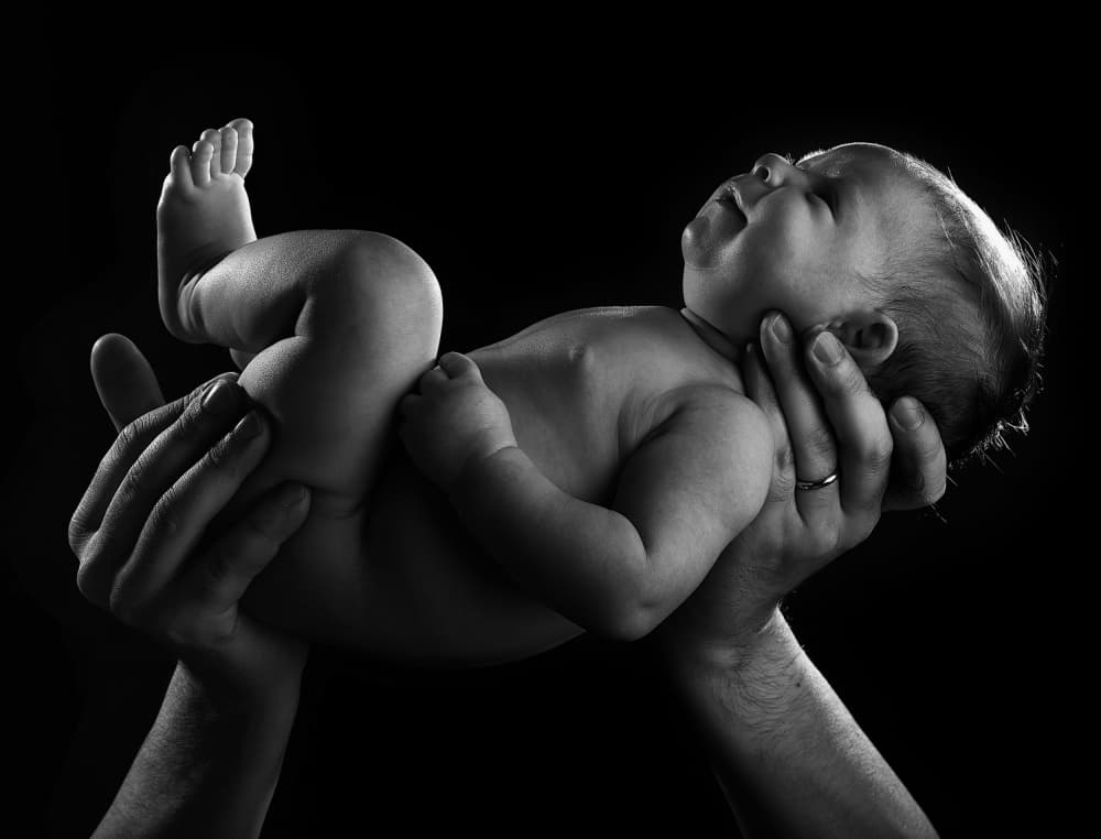Newborn in Loving Hands by Abbas Arabzadeh — canvas wall art