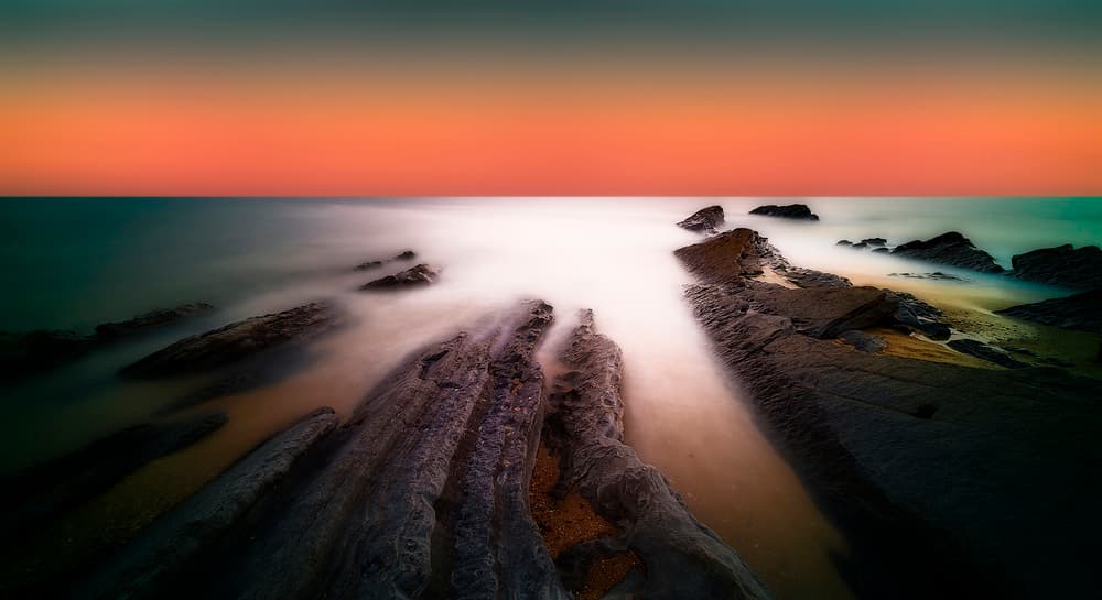 Tranquil Rocky Ocean Sunset by Paulo Abrantes — canvas wall art