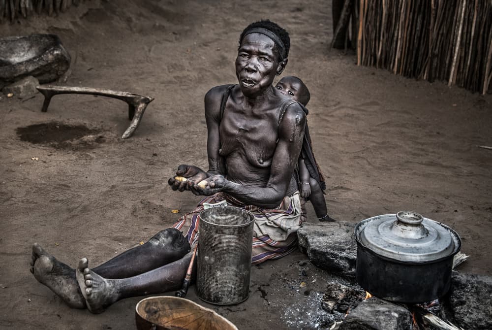 African Mother Village Cooking by Joxe Inazio Kuesta Garmendia — canvas wall art
