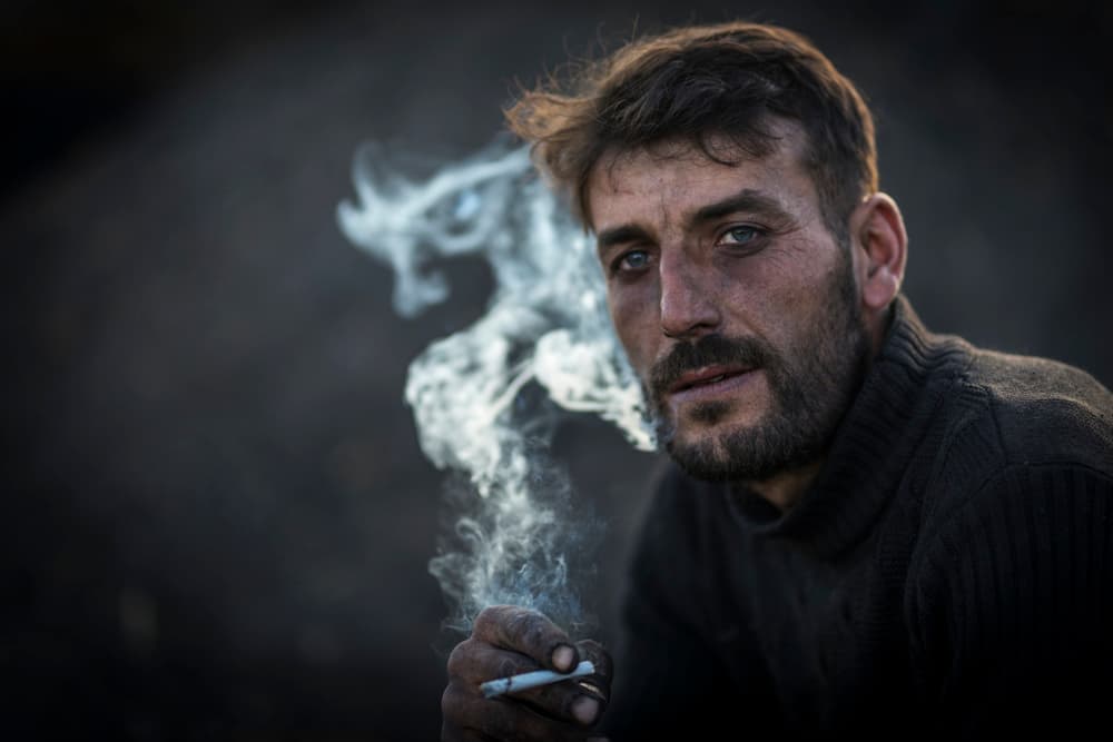 Gritty Man Smoking by Mustafa Binol — canvas wall art