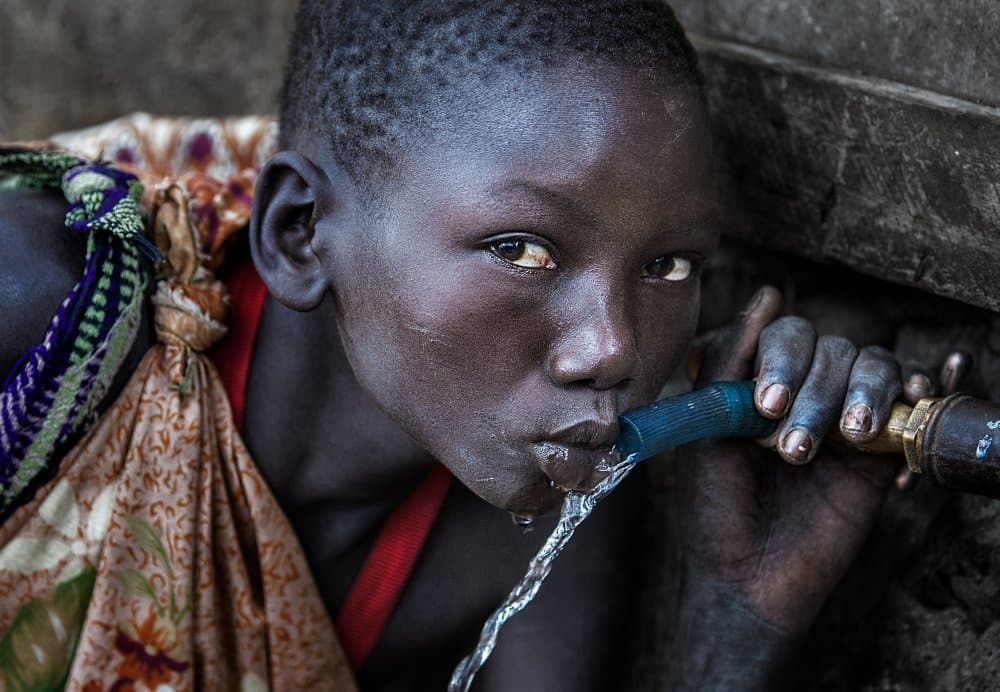 Young Person Drinking Water by Joxe Inazio Kuesta Garmendia — canvas wall art