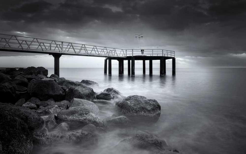 Moody Ocean Pier by Joaquin Guerola — canvas wall art