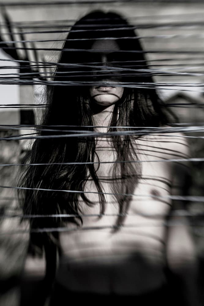 Mysterious Woman Behind Wires by Bogdan Bouşcă — canvas wall art