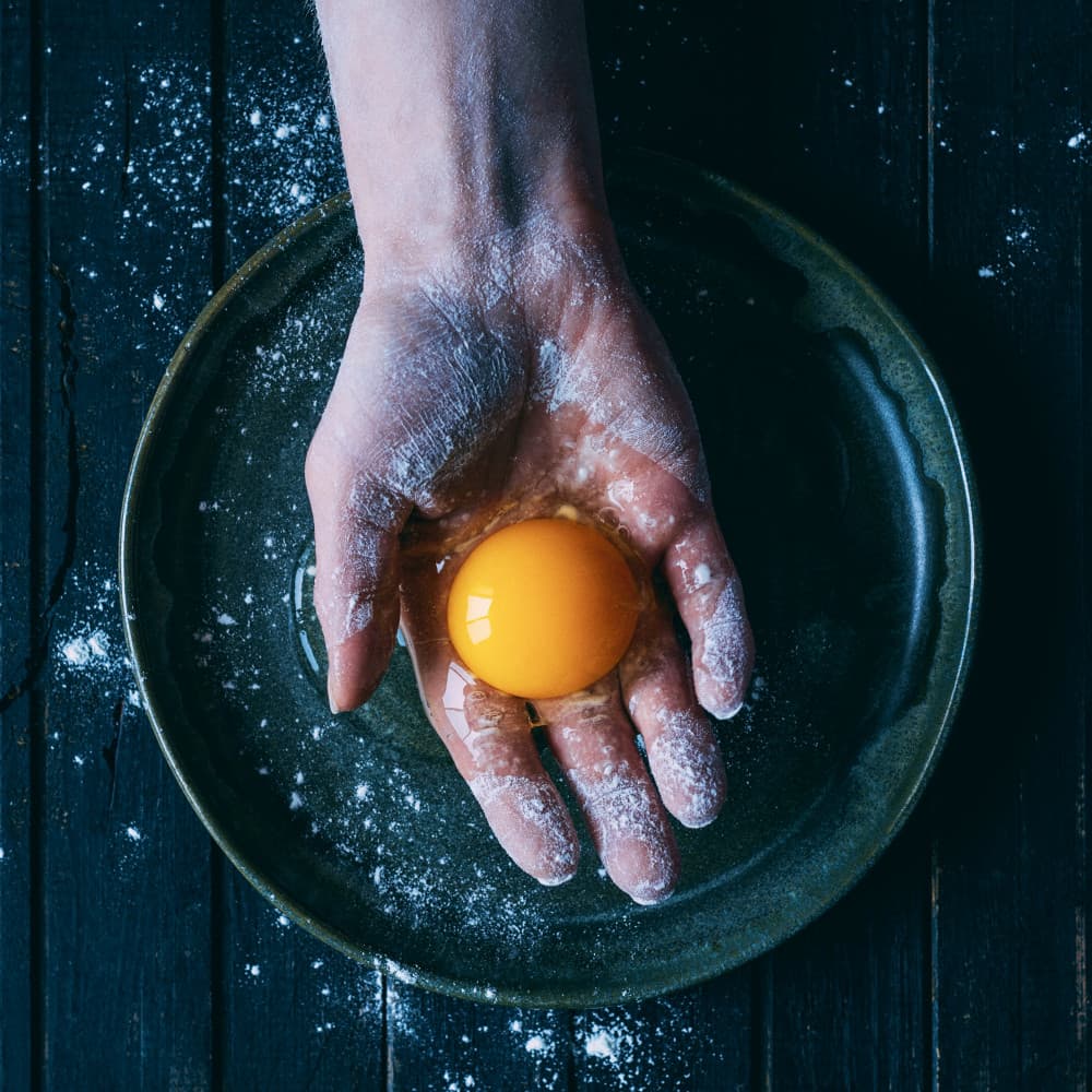 Raw Egg In Hand by Karina Aleksandrova — canvas wall art