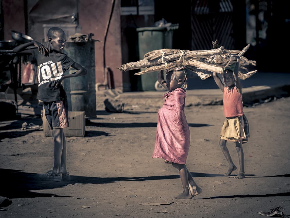 African Children Carrying Firewood by Eyal Alcalay — canvas wall art