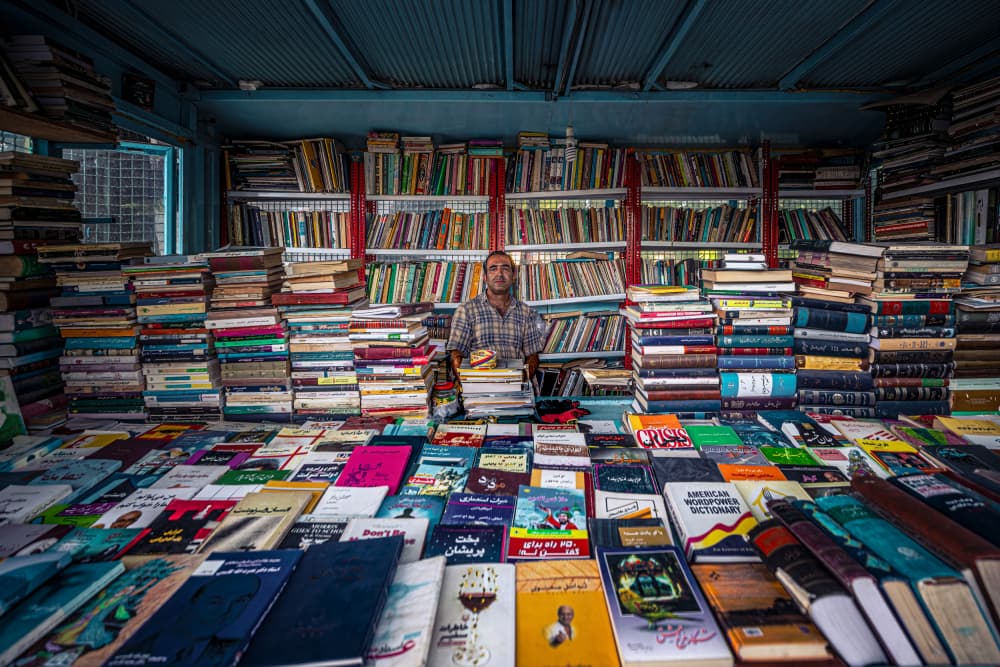 Bookseller Among Books by Marco Tagliarino — canvas wall art