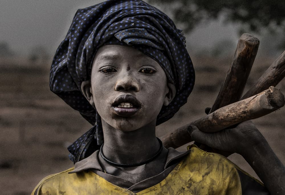 Young African Carrying Wood by Joxe Inazio Kuesta Garmendia — canvas wall art